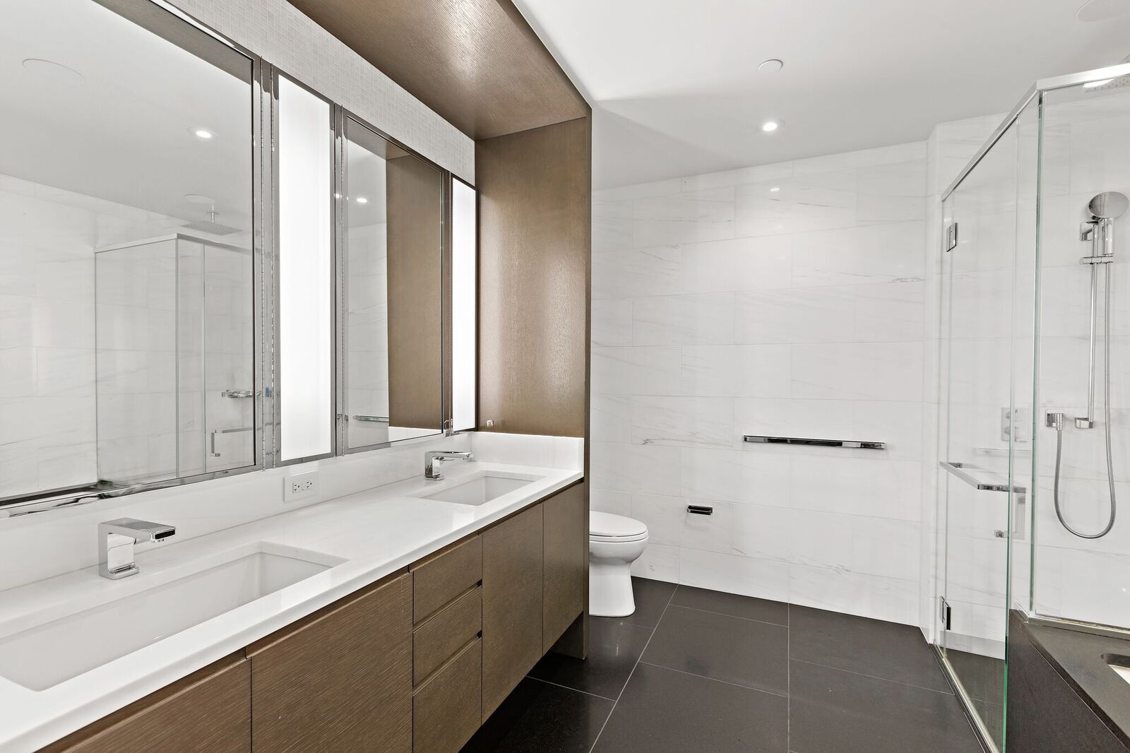 50 Riverside Boulevard, Unit 11H Manhattan, NY 10069 - Photo 7 of 37 a bathroom with a double vanity sink mirror and toilet