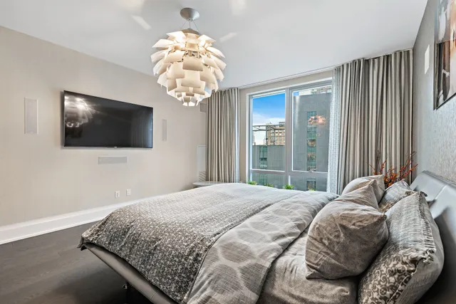 a bedroom with a bed and a flat screen tv