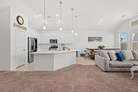 a spacious bedroom with a bed and a flat screen tv