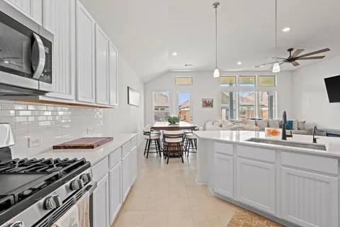 a view of walk in closet with clothes