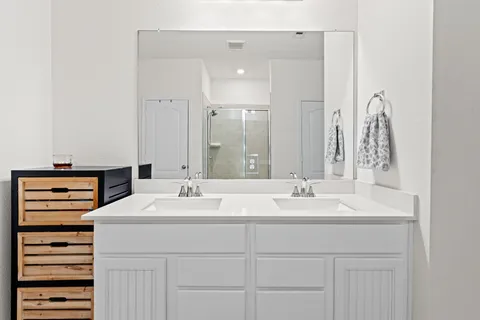 a bathroom with a sink toilet and mirror