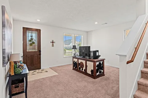 a view of a dining room with furniture and a window