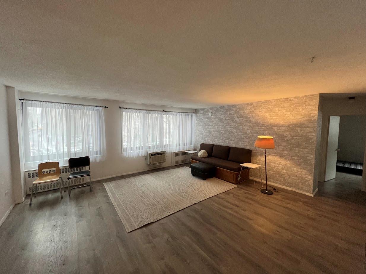 77 Fulton Street, Unit 2J Manhattan, NY 10038 - Photo 11 of 20 a living room with furniture window and wooden floor