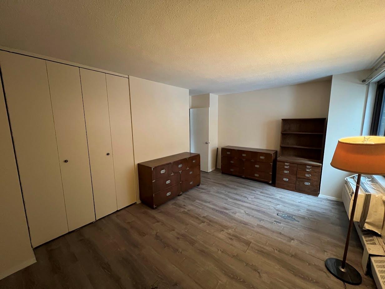 77 Fulton Street, Unit 2J Manhattan, NY 10038 - Photo 13 of 20 a view of a workspace with furniture and wooden floor