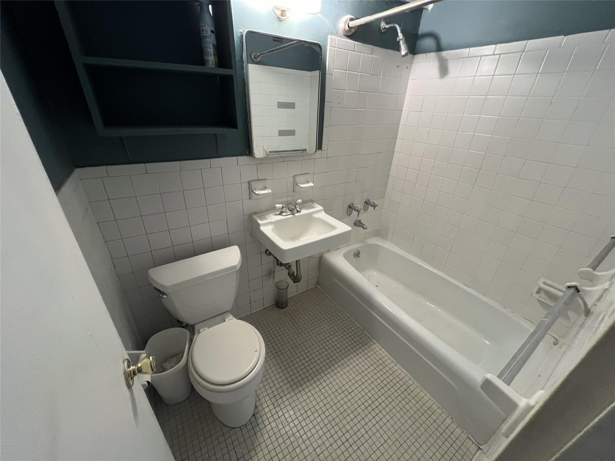 77 Fulton Street, Unit 2J Manhattan, NY 10038 - Photo 16 of 20 a bathroom with a sink toilet and shower