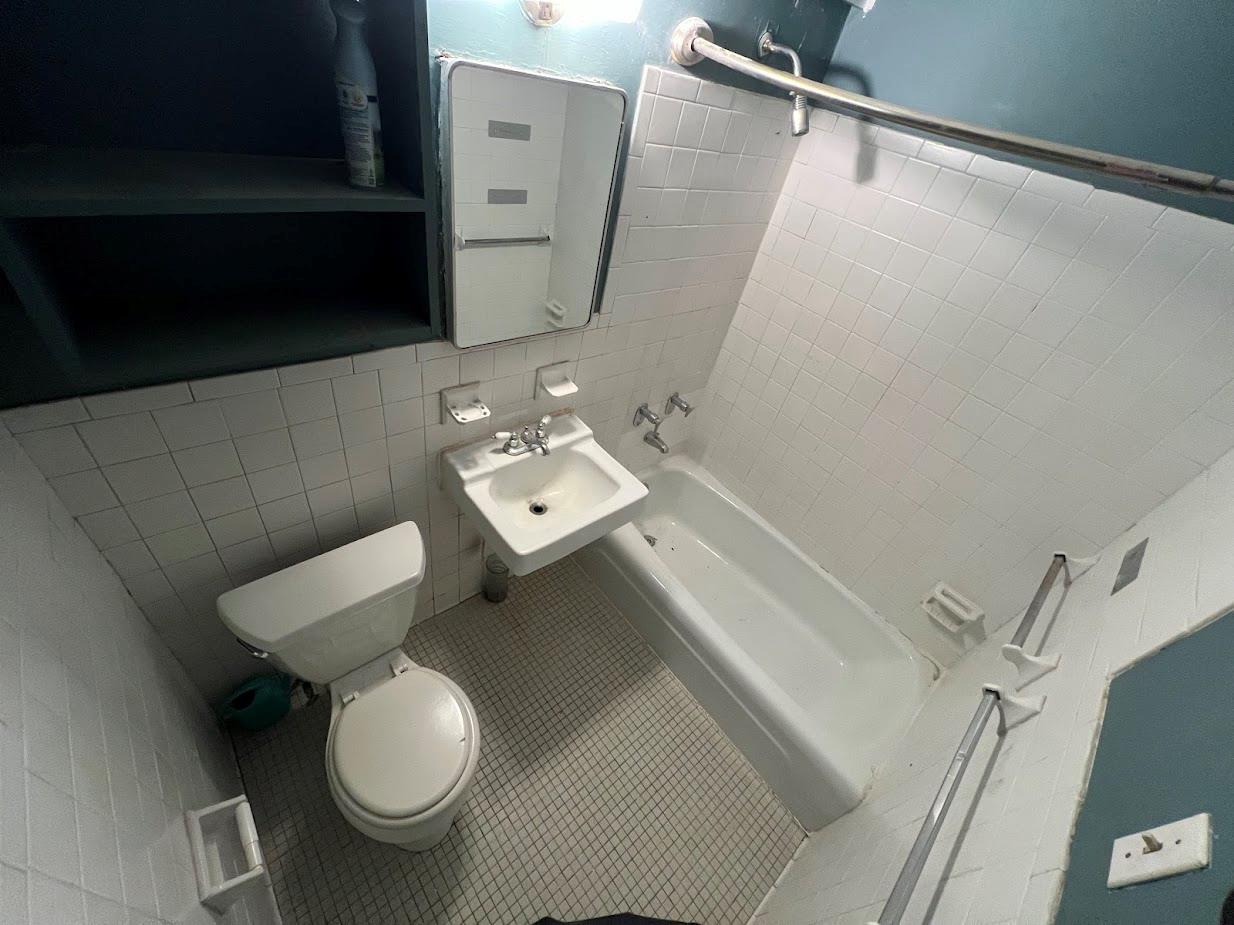 77 Fulton Street, Unit 2J Manhattan, NY 10038 - Photo 17 of 20 a bathroom with a toilet and a sink