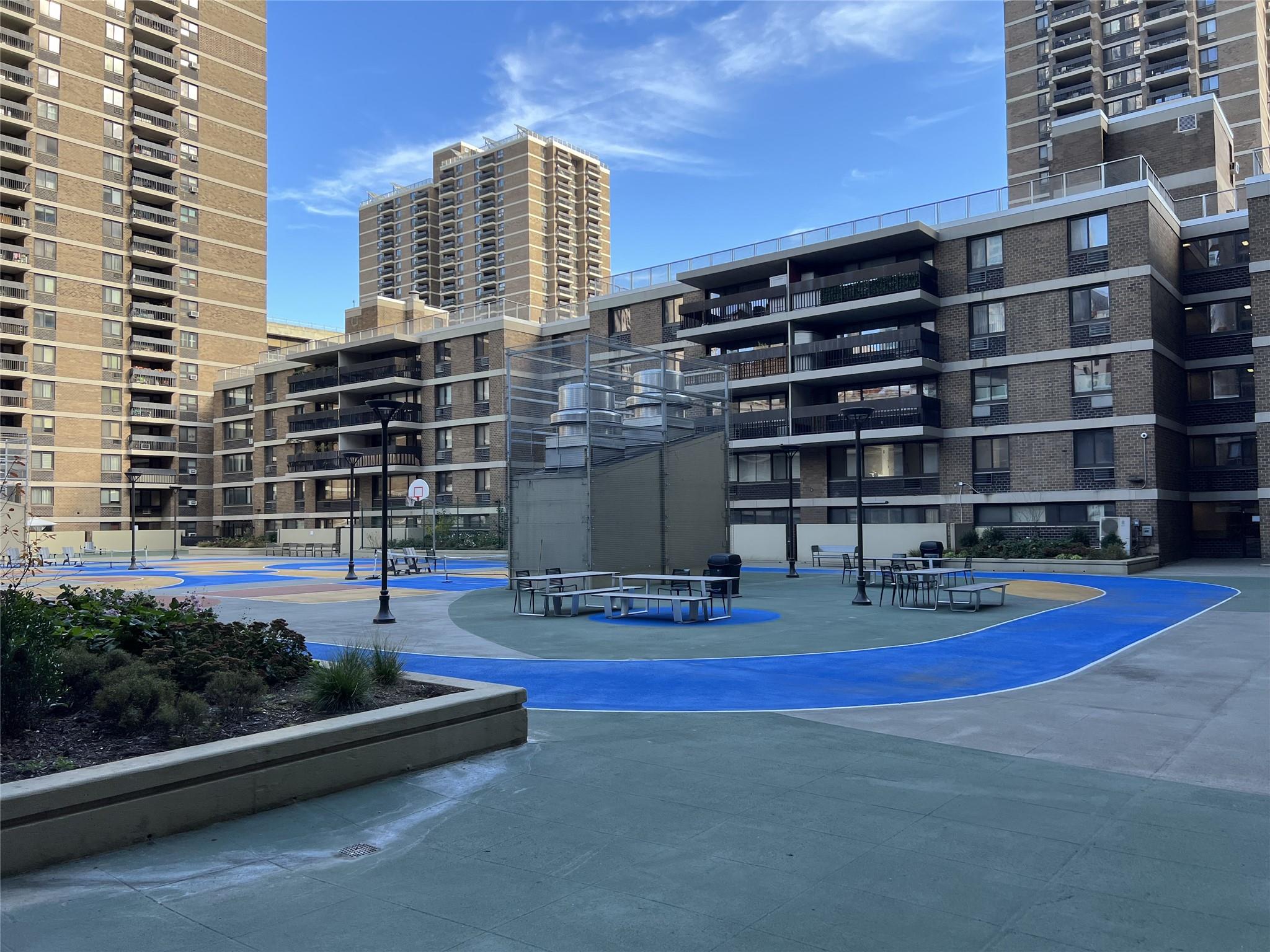 77 Fulton Street, Unit 2J Manhattan, NY 10038 - Photo 20 of 20 a view of tall buildings and outdoor seating