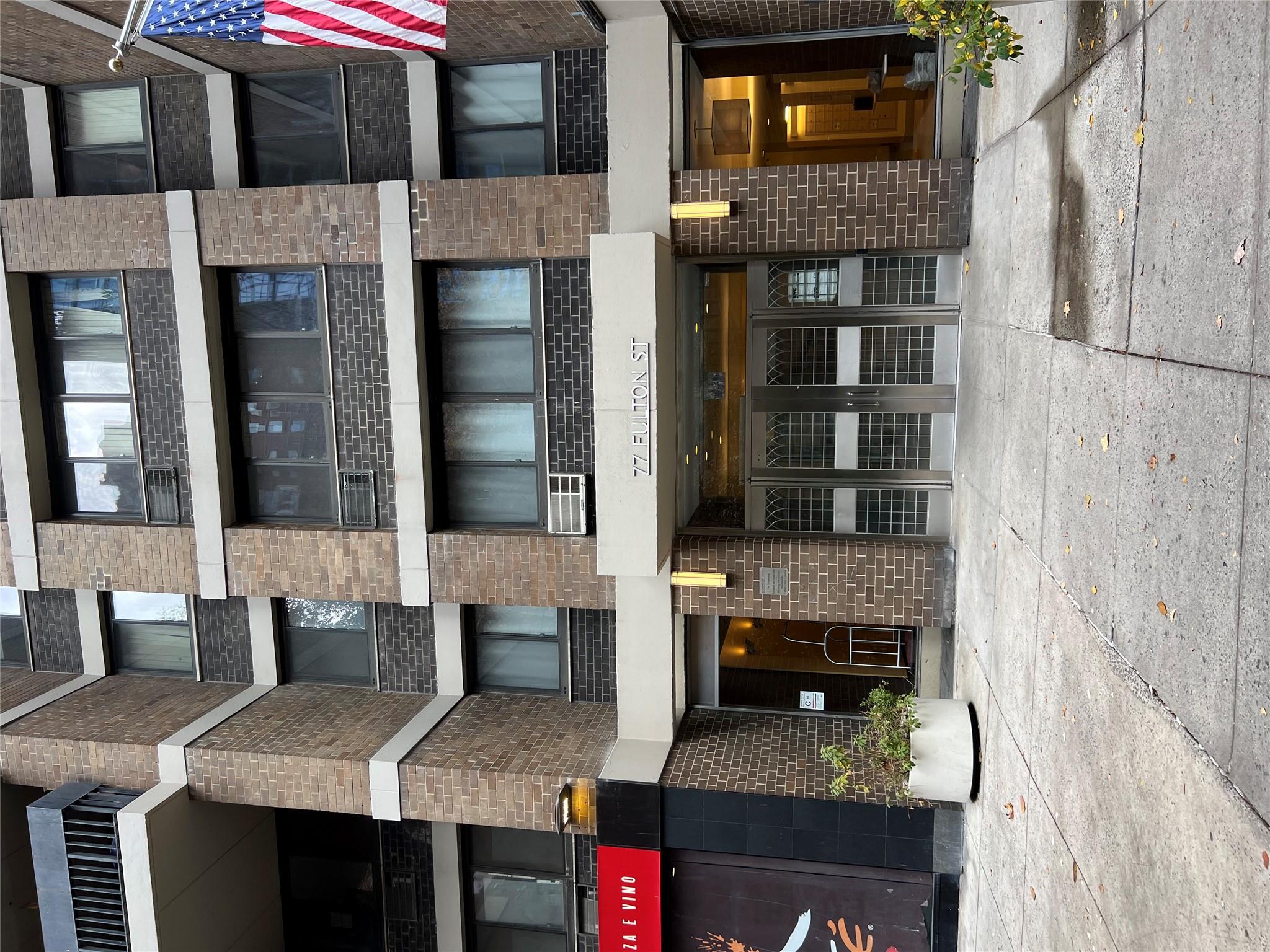 77 Fulton Street, Unit 2J Manhattan, NY 10038 - Photo 2 of 20 a front view of a building with a glass windows