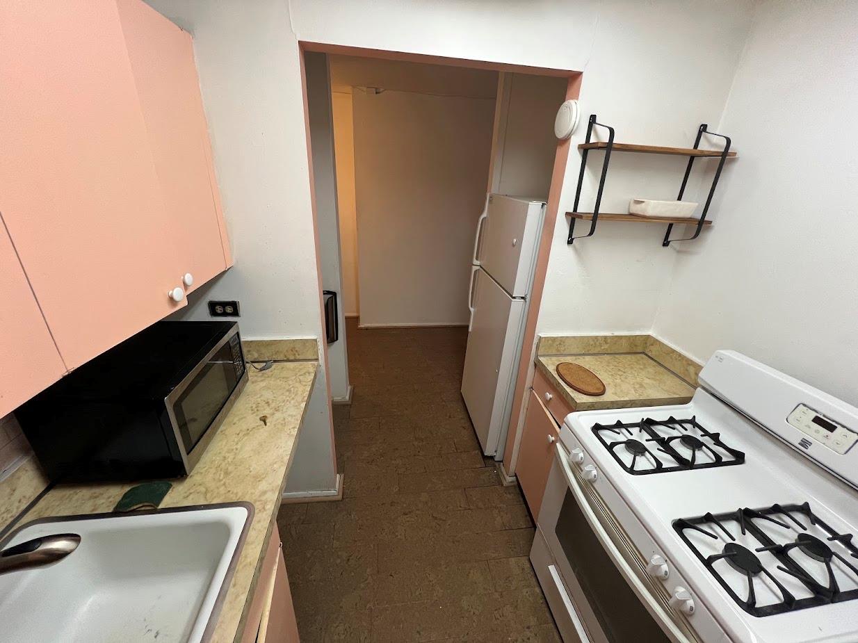 77 Fulton Street, Unit 2J Manhattan, NY 10038 - Photo 6 of 20 a view of kitchen appliances and cabinets