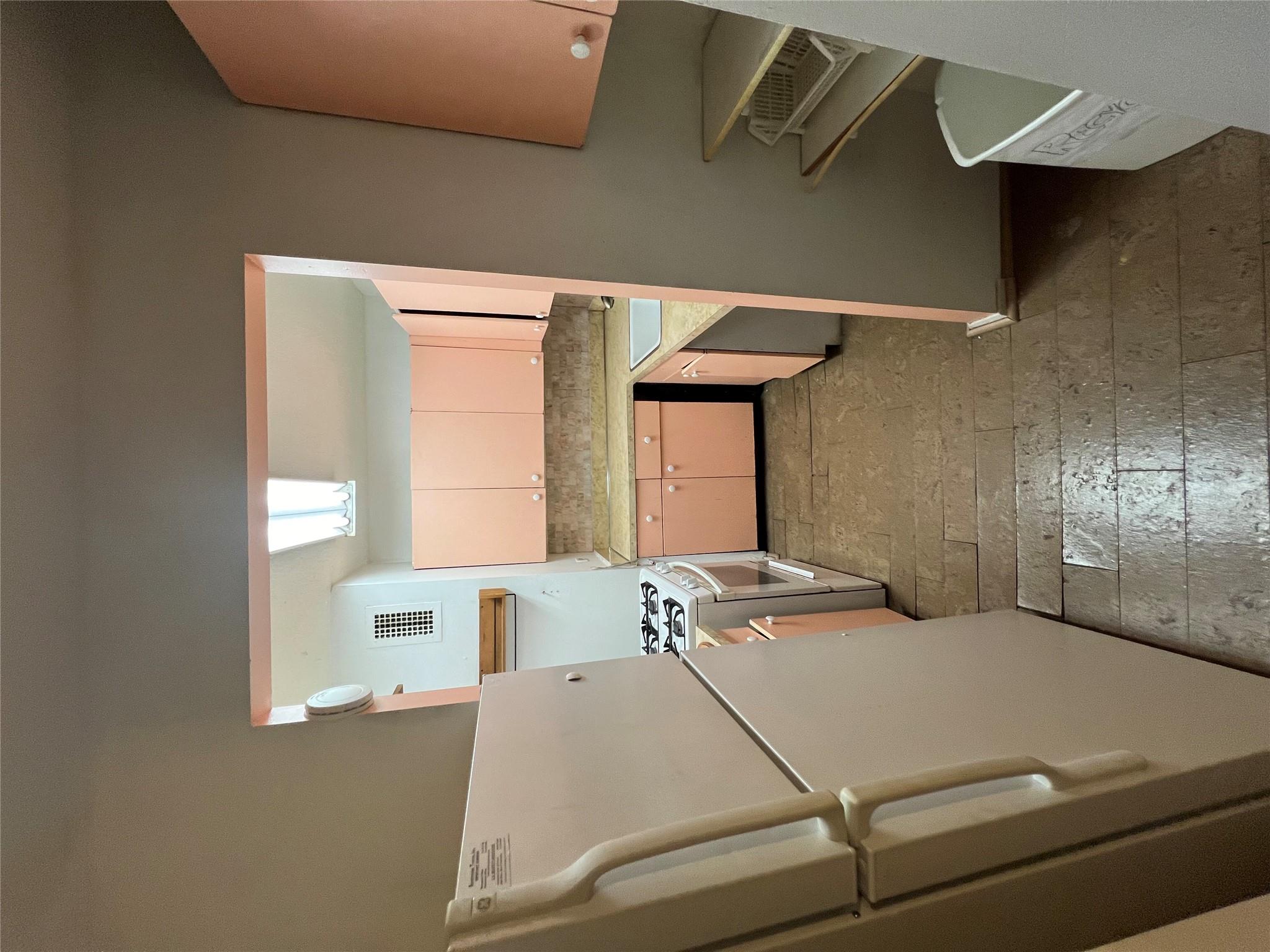 77 Fulton Street, Unit 2J Manhattan, NY 10038 - Photo 7 of 20 a kitchen with a refrigerator and a stove