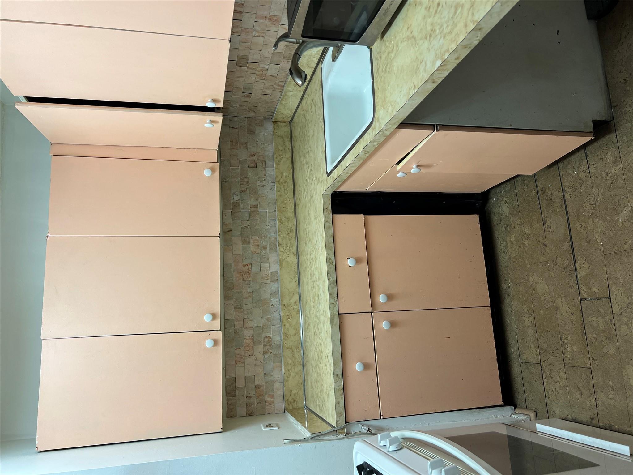 77 Fulton Street, Unit 2J Manhattan, NY 10038 - Photo 8 of 20 a kitchen with a sink and cabinets