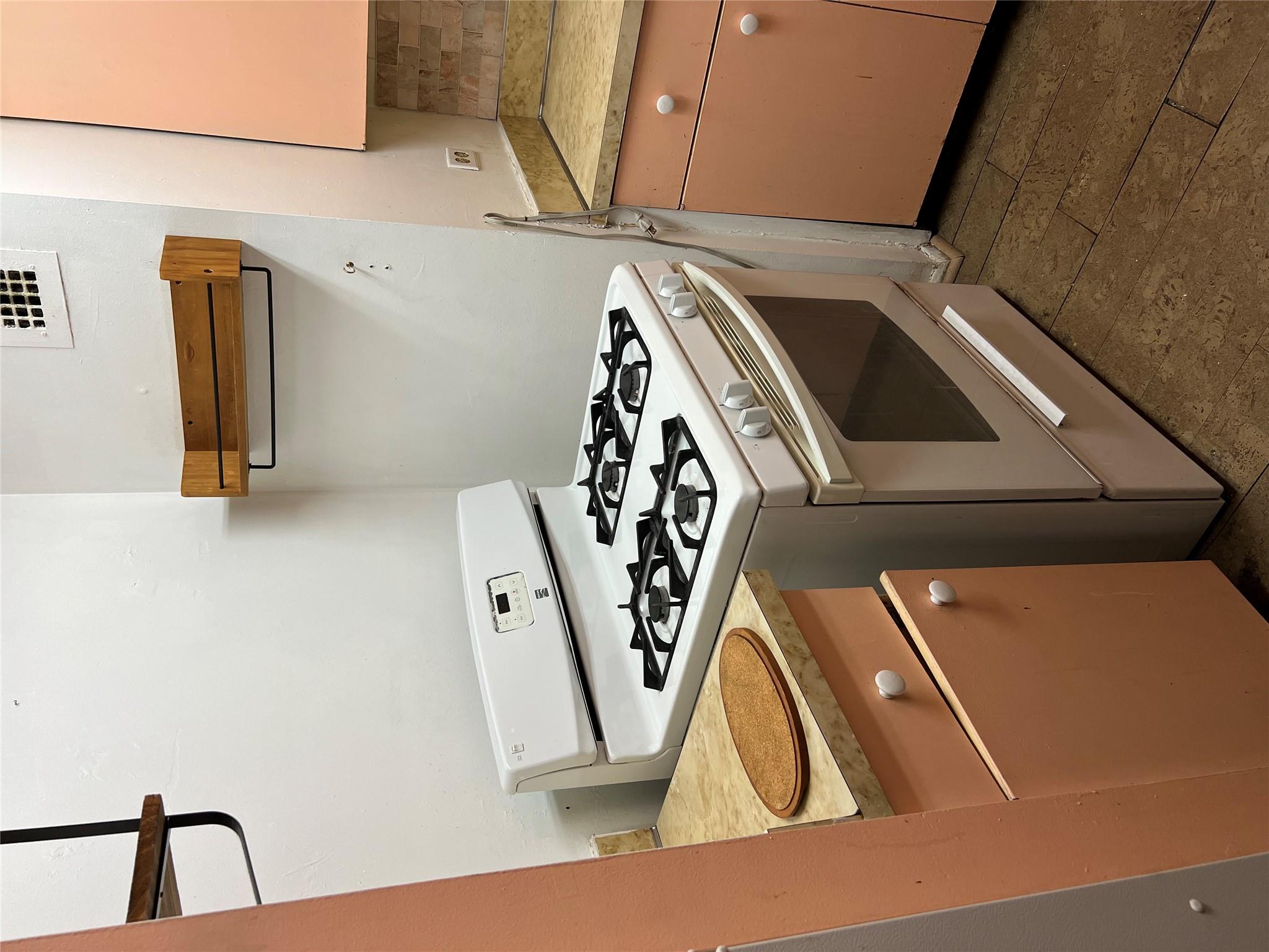 77 Fulton Street, Unit 2J Manhattan, NY 10038 - Photo 9 of 20 a white stove top oven sitting inside of a kitchen