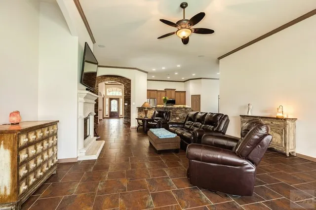 a living room with furniture a fireplace and a flat screen tv