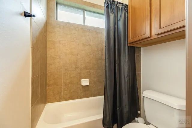 a living room with a bed and a chandelier