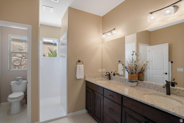 1587 Whitestone Drive St. George, UT 84790 - Photo 15 of 36 Dual vanity with granite-style countertop and dark wood-finish cabinetry