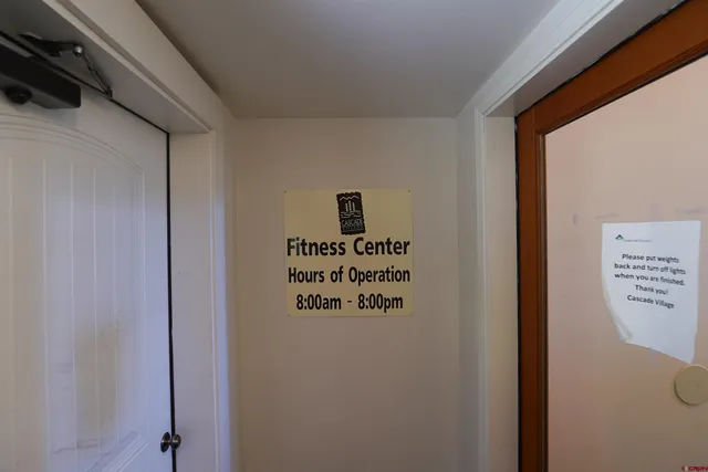 a view of a room with gym equipment and floor to ceiling windows