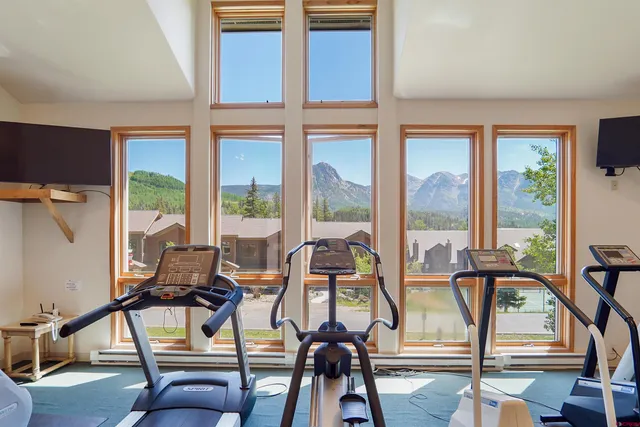 a living room with furniture and large windows
