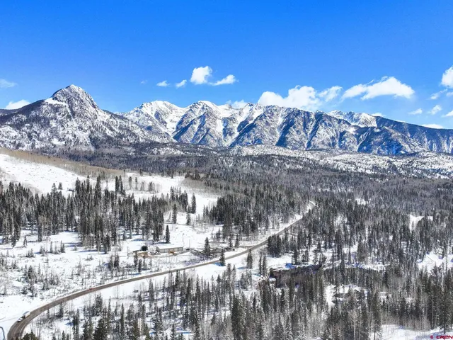 a view of a house with a snow in the background