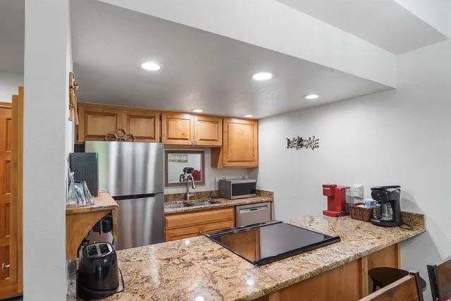 a kitchen with refrigerator and window