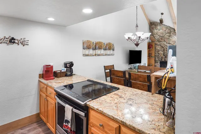 a kitchen that has a stove and a table