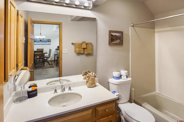 a bathroom with a sink a toilet and shower curtain