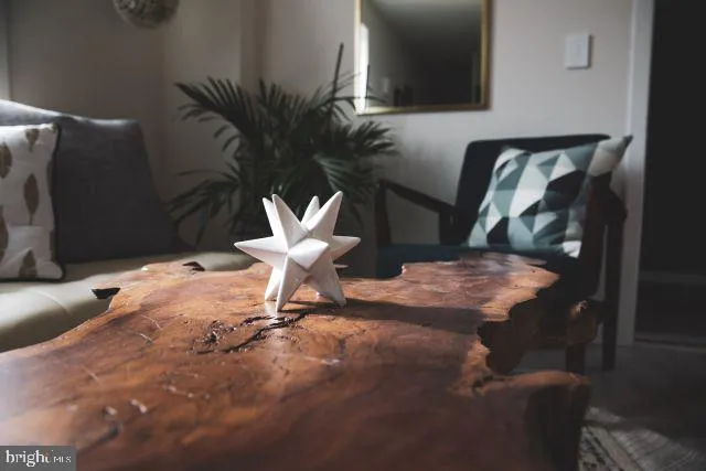 a view of a room with furniture and wooden floor