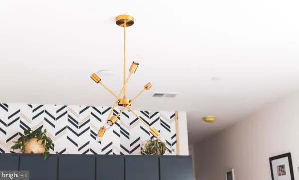 a kitchen with stainless steel appliances a stove microwave and sink