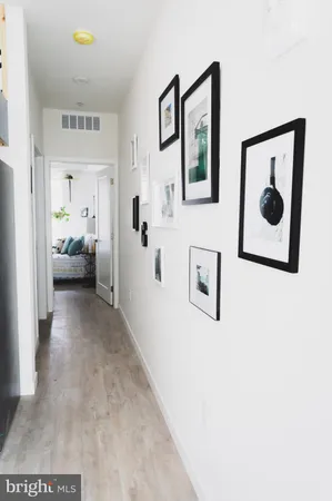 a room with painting on the wall and a window