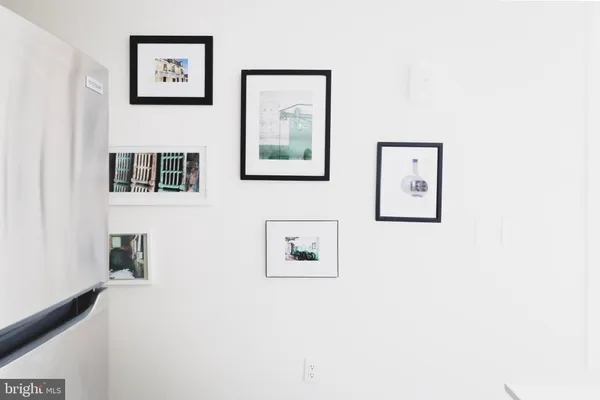 a bedroom with a bed and a lamp on dresser