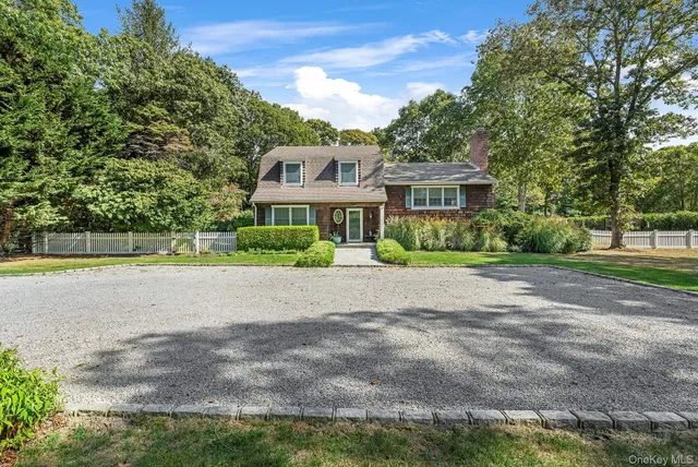 a house with a yard and a large parking space