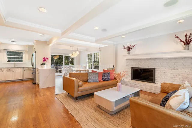 a living room with fireplace furniture and a wooden floor