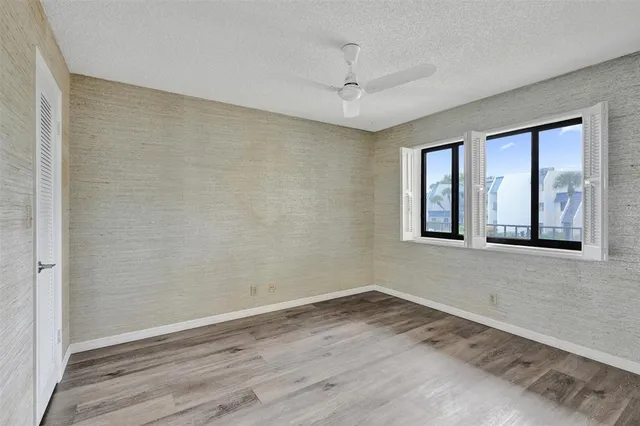 a view of a bathroom with shower and mirror