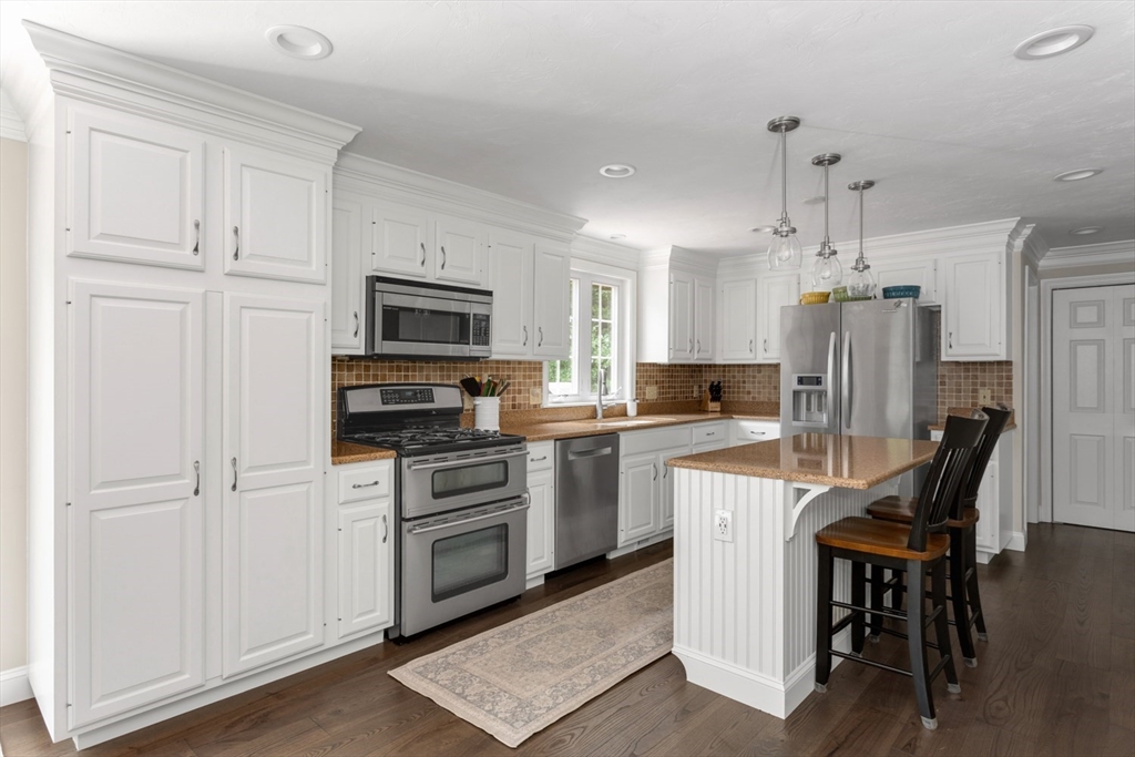 5 Wadsworth Farm Road Franklin, MA 02038 - Photo 2 of 42 a kitchen with white cabinets and stainless steel appliances