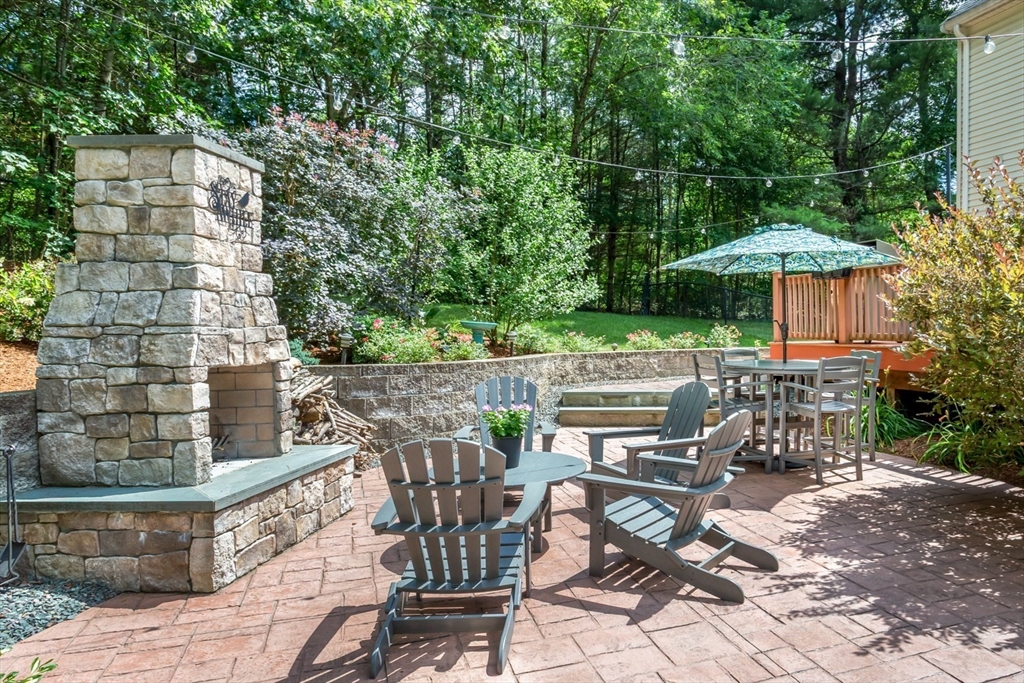 5 Wadsworth Farm Road Franklin, MA 02038 - Photo 34 of 42 a view of a patio with table and chairs potted plants with wooden floor and fence