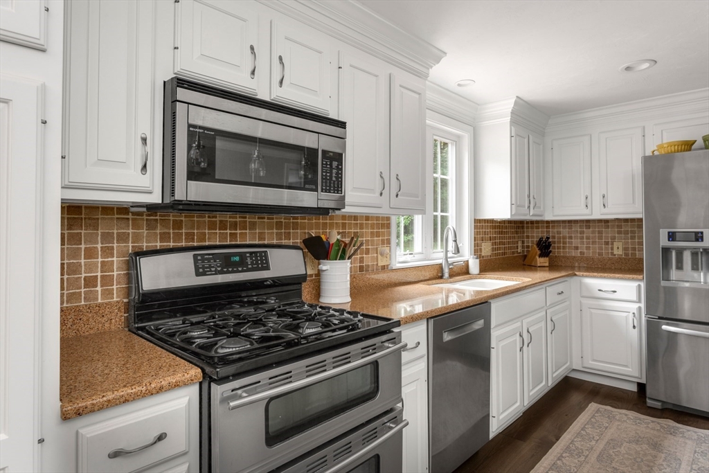 5 Wadsworth Farm Road Franklin, MA 02038 - Photo 10 of 42 a kitchen with cabinets stainless steel appliances and a sink