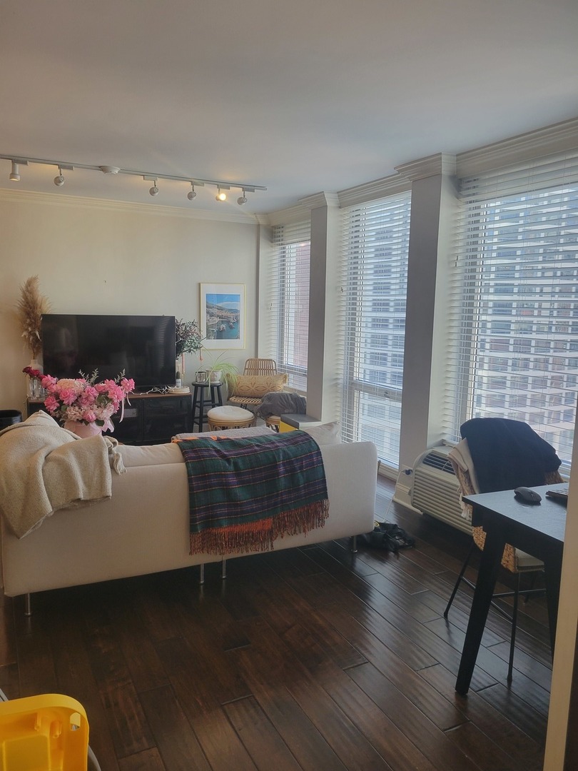 111 East Chestnut Street, Unit 20D Chicago, IL 60611 - Photo 3 of 8 a bedroom with a bed and wooden floor