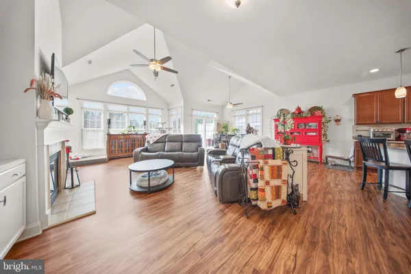 a living room with lots of furniture and kitchen view
