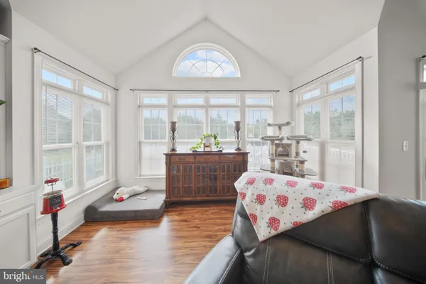 a bedroom with furniture and a large window