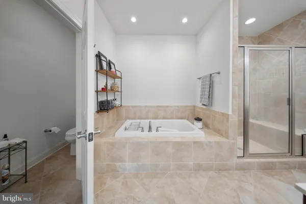 a bathroom with a tub sink and mirror