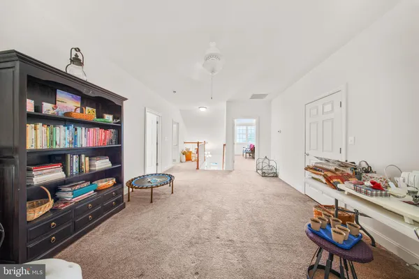 a hallway with furniture and book shelf