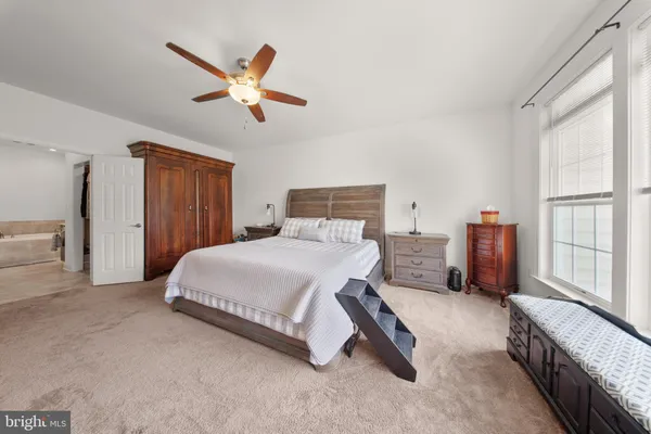 a bedroom with a bed dresser and a window