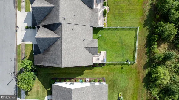 an aerial view of a house with a yard basket ball court and outdoor seating