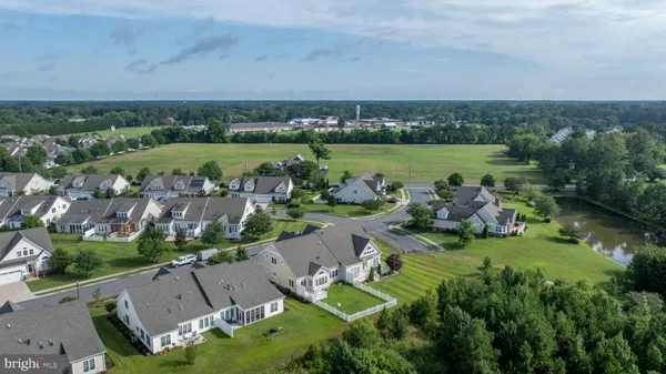 an aerial view of a house with a garden and lake view