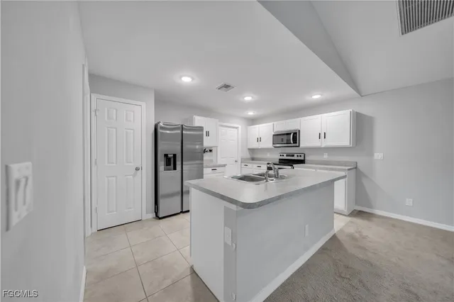 a kitchen with stainless steel appliances a sink stove and refrigerator