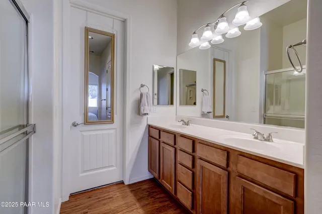 a bathroom with a double vanity sink and a mirror
