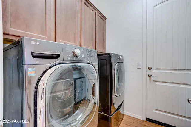 a view of walk in closet with washer and dryer