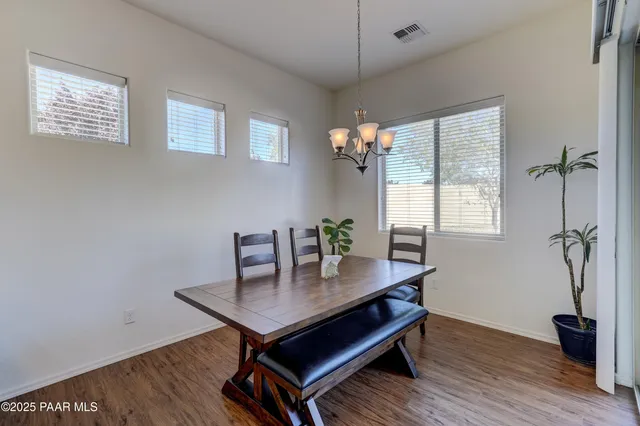 a view of a workspace with furniture and wooden floor