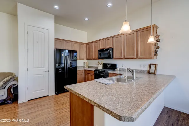 a kitchen with stainless steel appliances granite countertop a sink refrigerator and microwave
