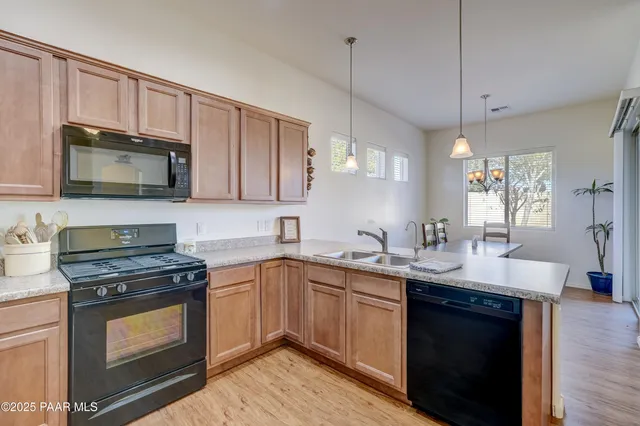 a kitchen with a sink stove and microwave