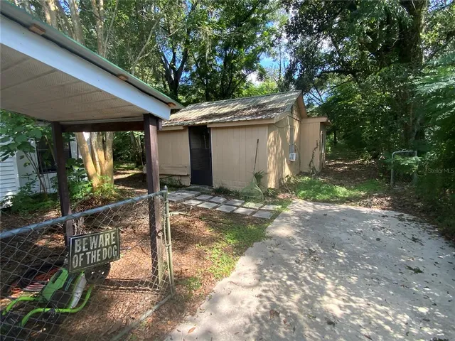 a backyard of a house with yard and outdoor seating